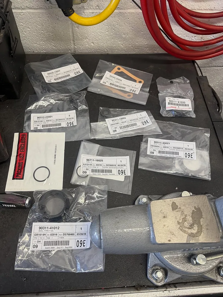 Genuine OEM Toyota parts laid out for a repair at Mesa Auto & Fleet